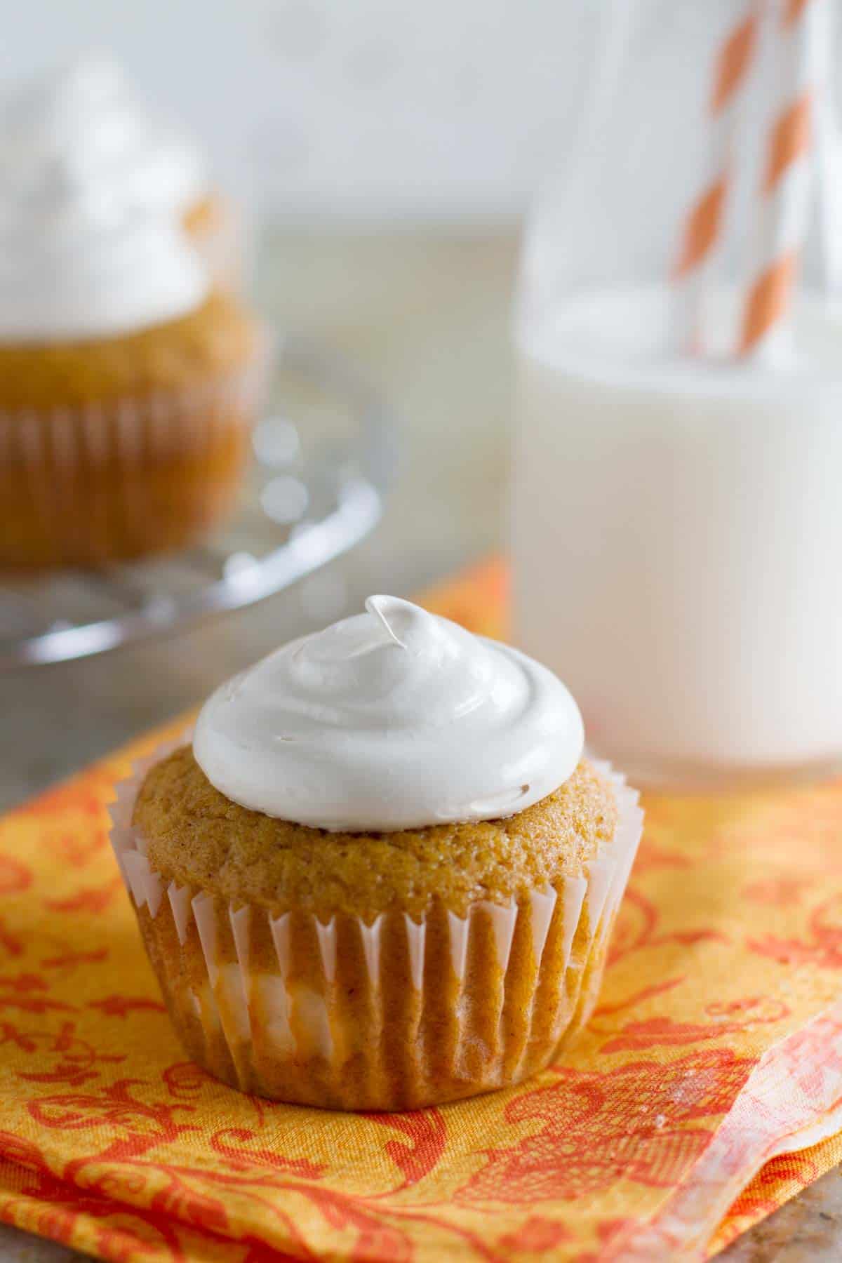 Pumpkin Cheesecake Cupcakes topped with Brown Sugar Marshmallow Frosting.