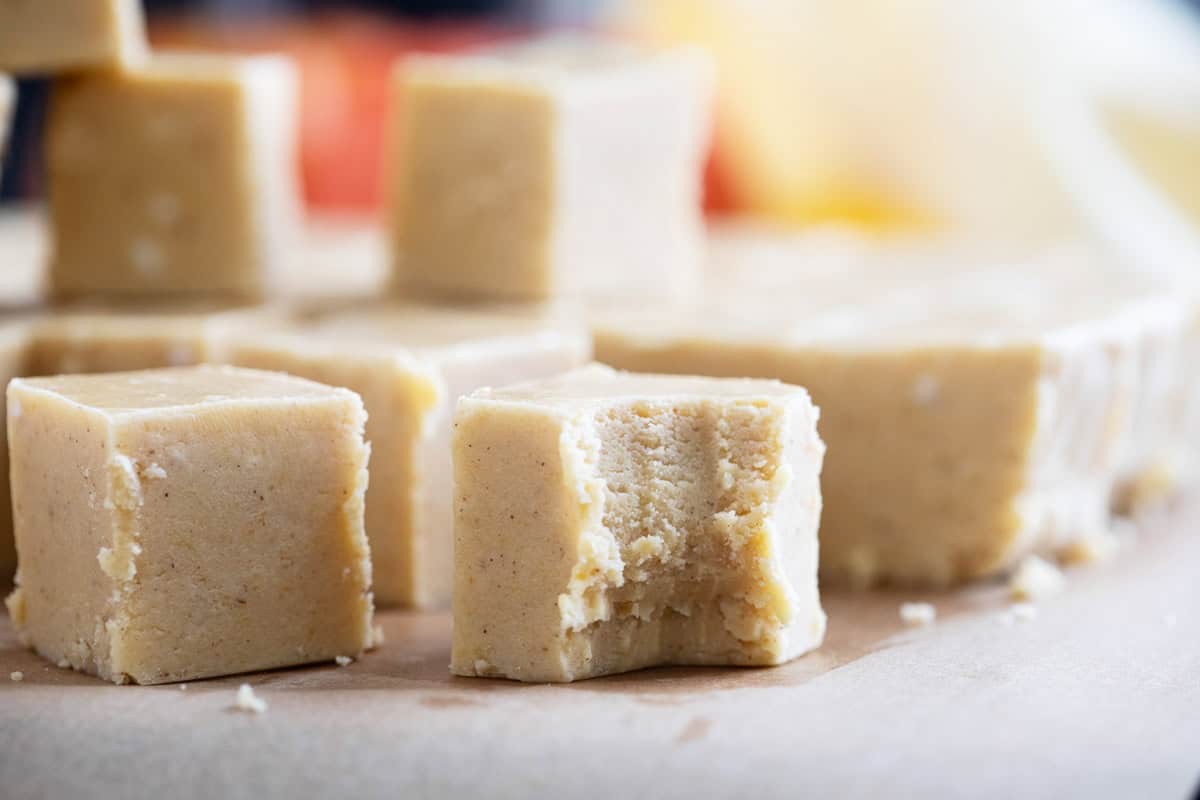 Squares of Pumpkin Fudge, with a bite taken from one piece.