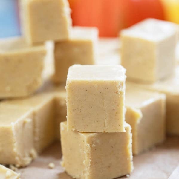 Squares of pumpkin fudge with some stacked on each other.