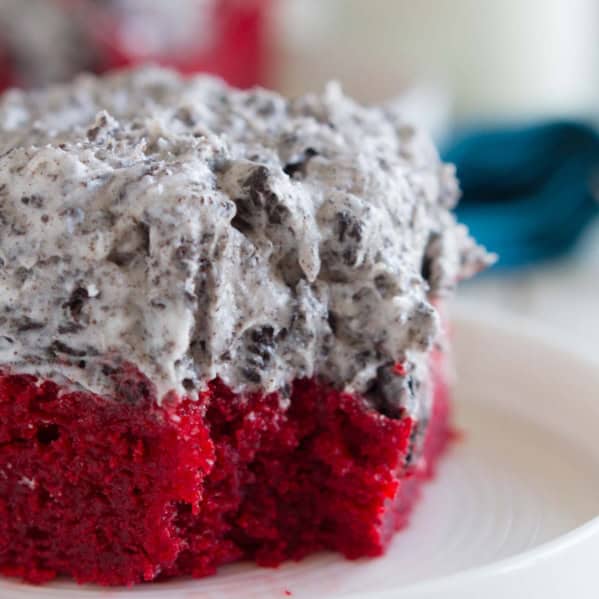 Slice of red velvet sheet cake with a bite taken from it.