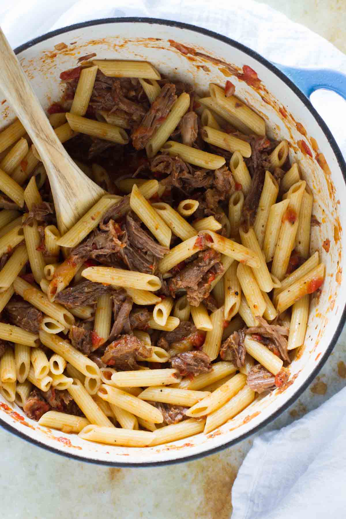 Slow Simmered Short Rib Sauce with Pasta in a Dutch oven.