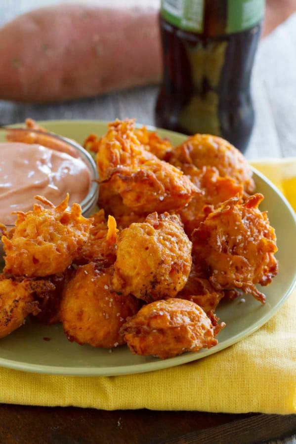 Sweet Potato Tots on a plate, with a bowl of creamy ketchup next to it.