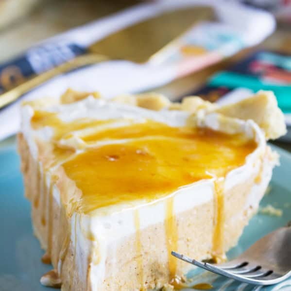 Slice of white chocolate caramel no bake pumpkin pie on a plate with a fork.