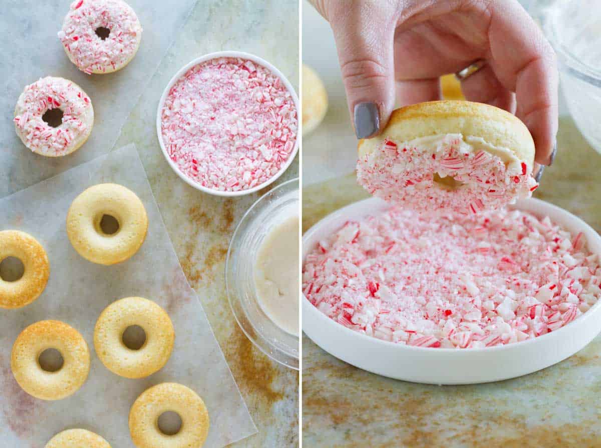 Baked peppermint donuts being dipped in crushed candy canes.