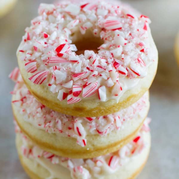 Three baked peppermint donuts stacked on top of each other.