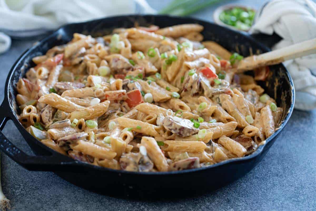 Cast iron skillet filled with Cajun Sausage Pasta.