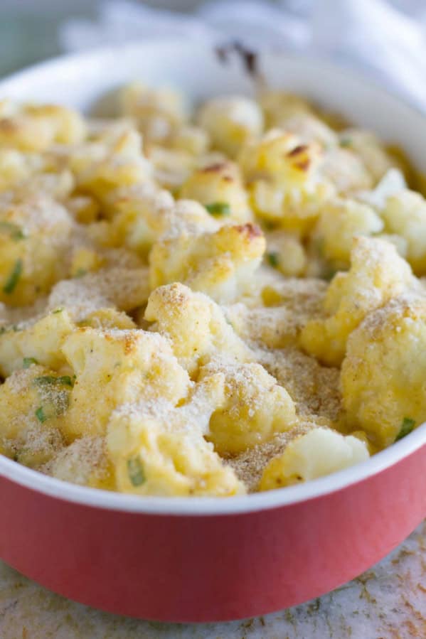 Baking dish filled with Cheddar Cauliflower Gratin topped with breadcrumbs.