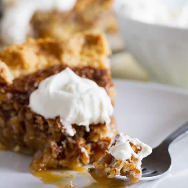 Fork full of coconut pecan pie on a plate.