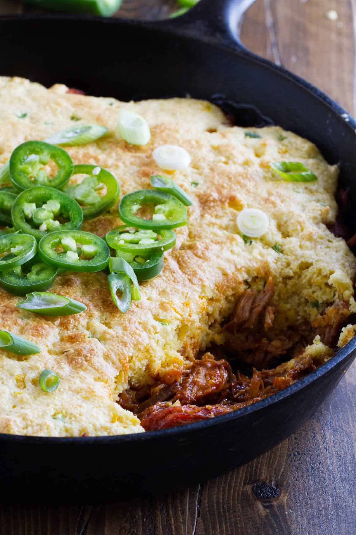 Cornbread Topped BBQ Pork with a scoop taken out.