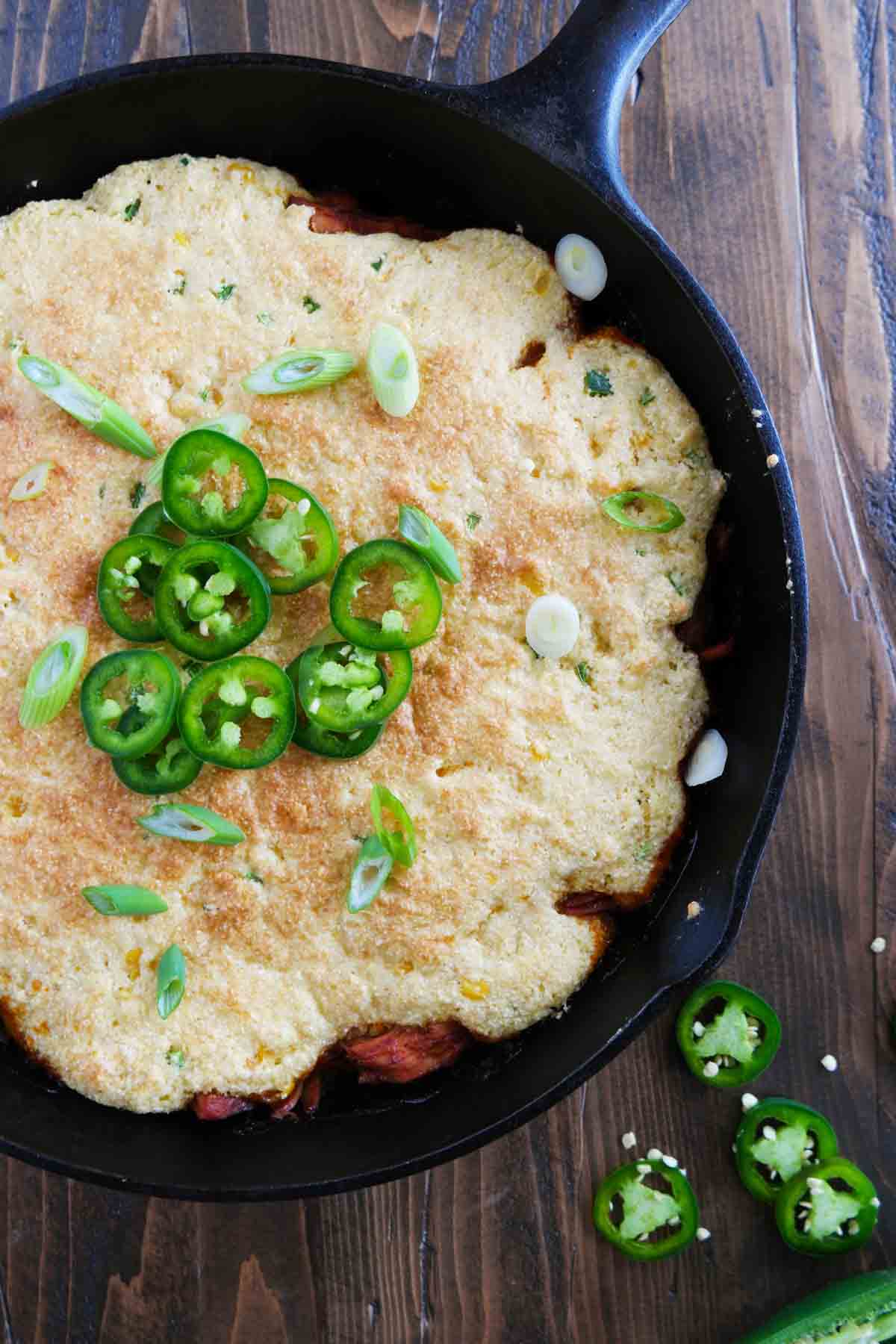 Cornbread Topped BBQ Pork in a cast iron skillet.