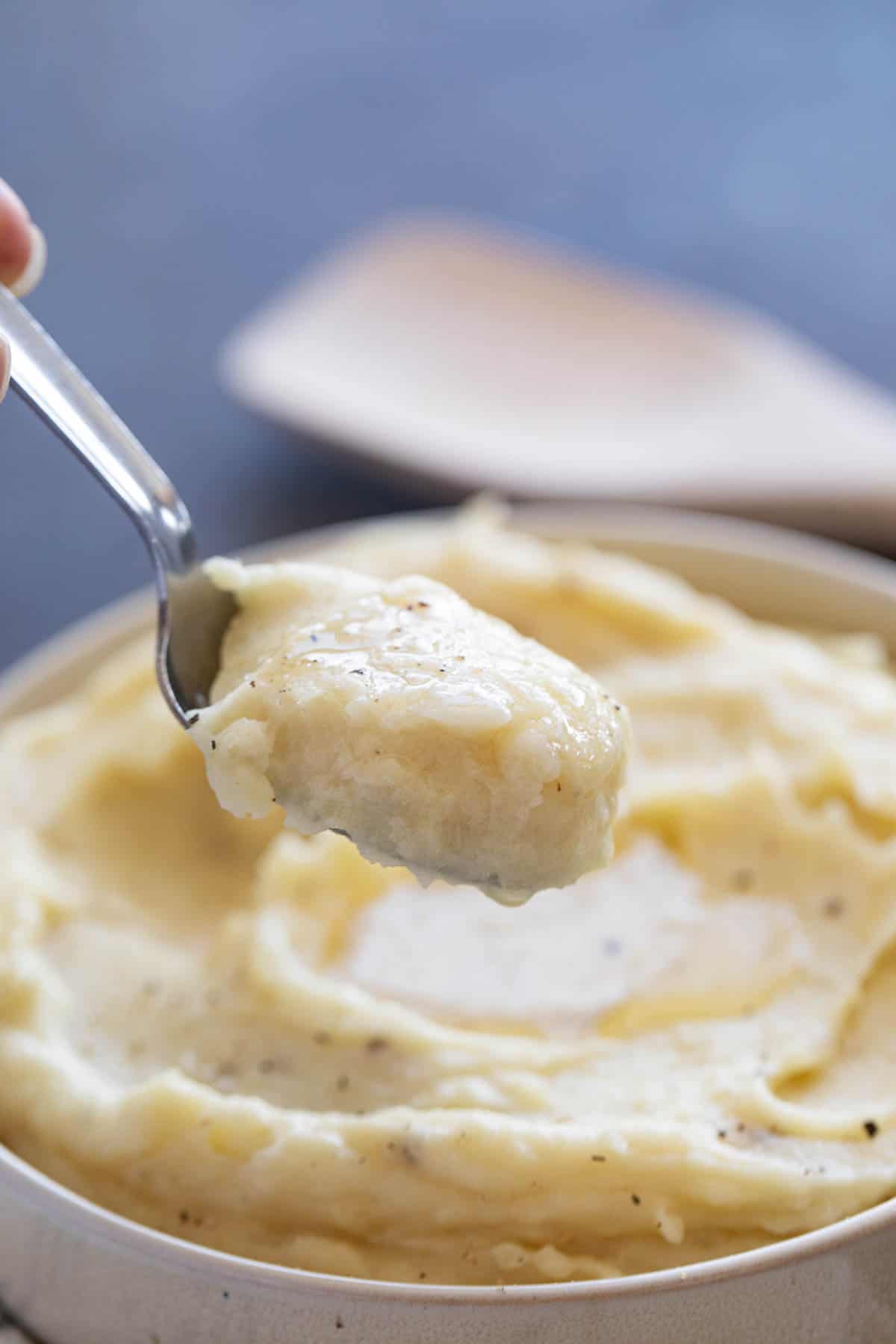 Spoon full of slow cooker mashed potatoes.