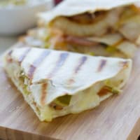 Sliced Cuban quesadillas on a cutting board.