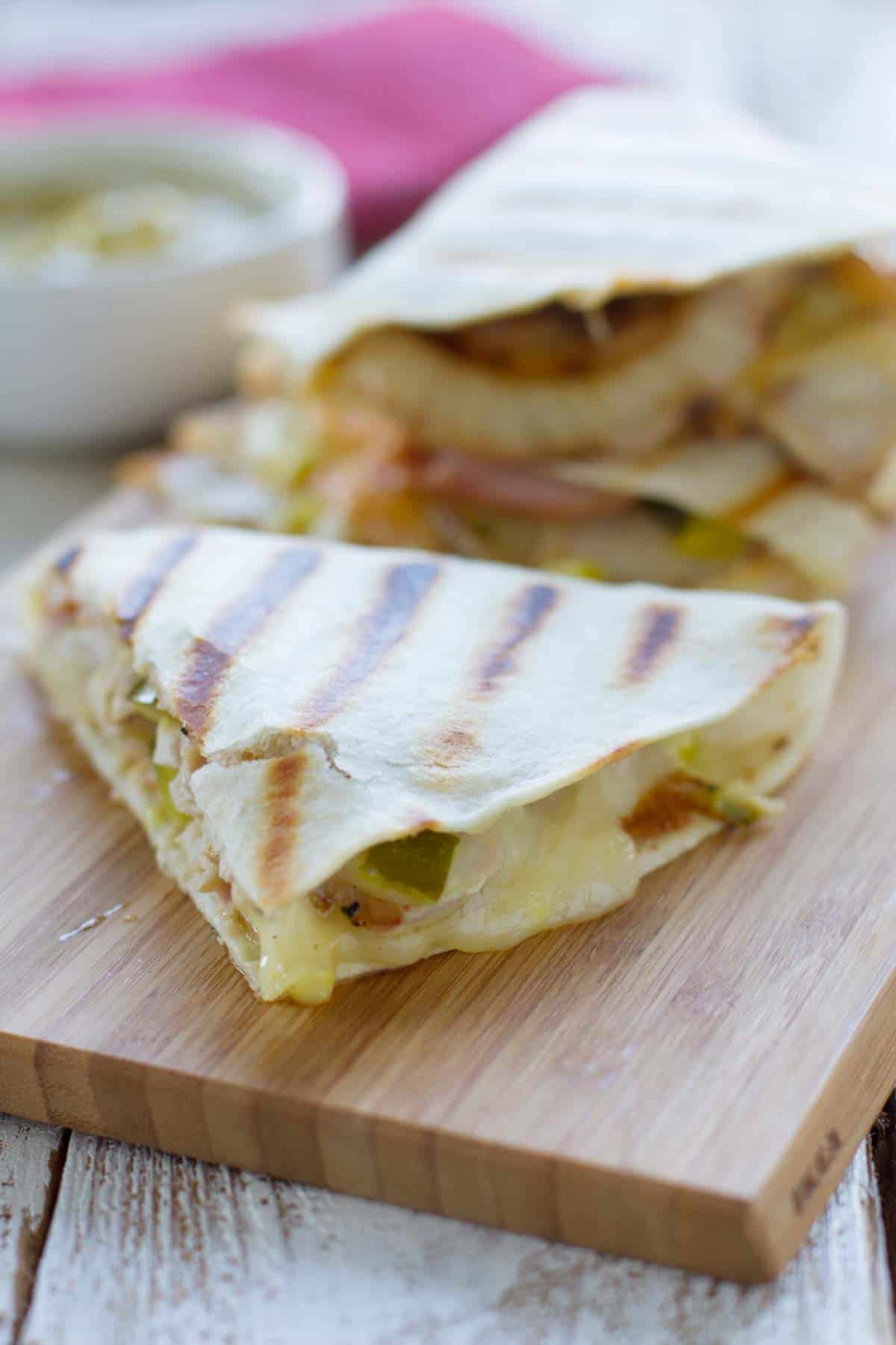 Sliced Cuban quesadillas on a cutting board.