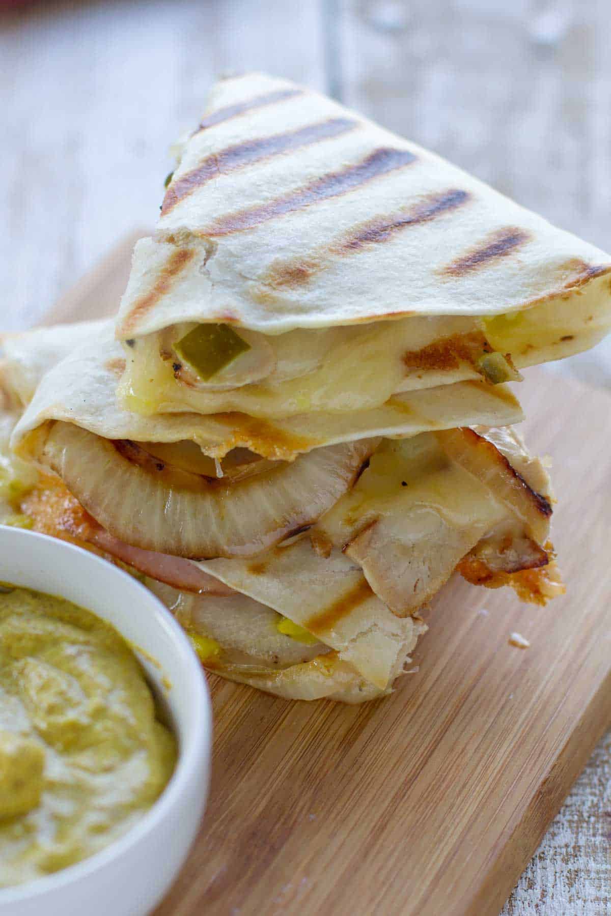 Cuban quesadilla triangles stacked on top of each other.