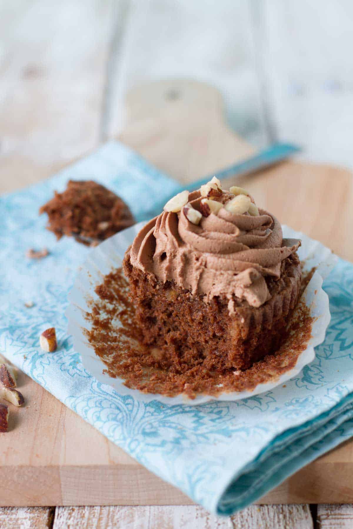 Hazelnut Brownie Cupcake with Hazelnut Buttercream with a bite taken from it.