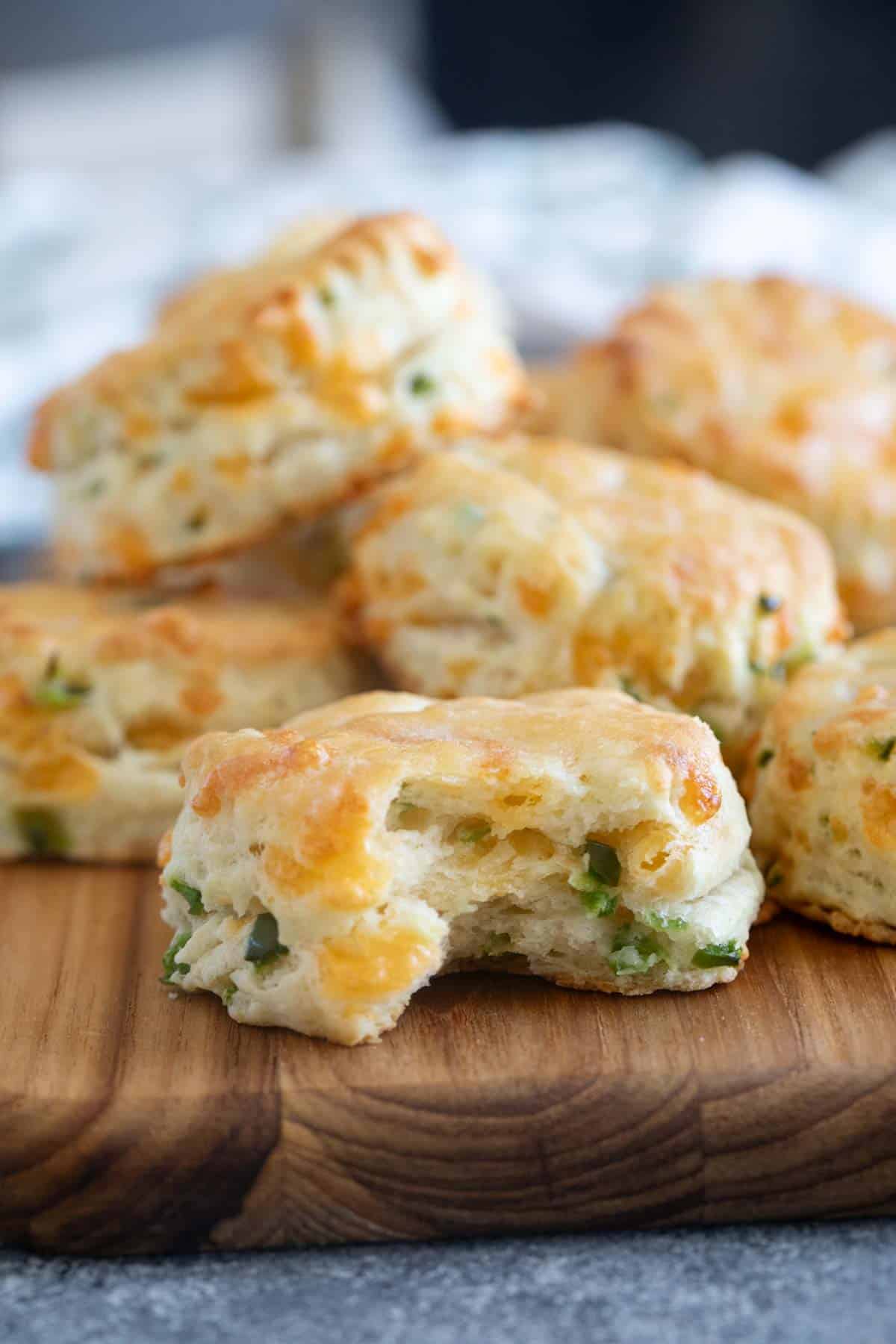 Jalapeno Cheddar Biscuits with a bite taken from one.