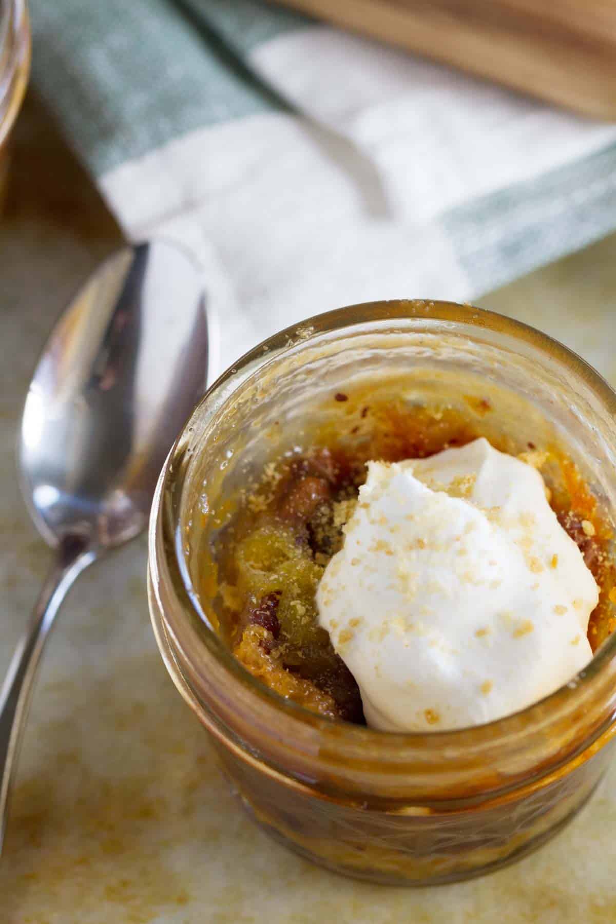 Close up of Mini Chocolate Pecan Pie in a Jar topped with whipped cream.