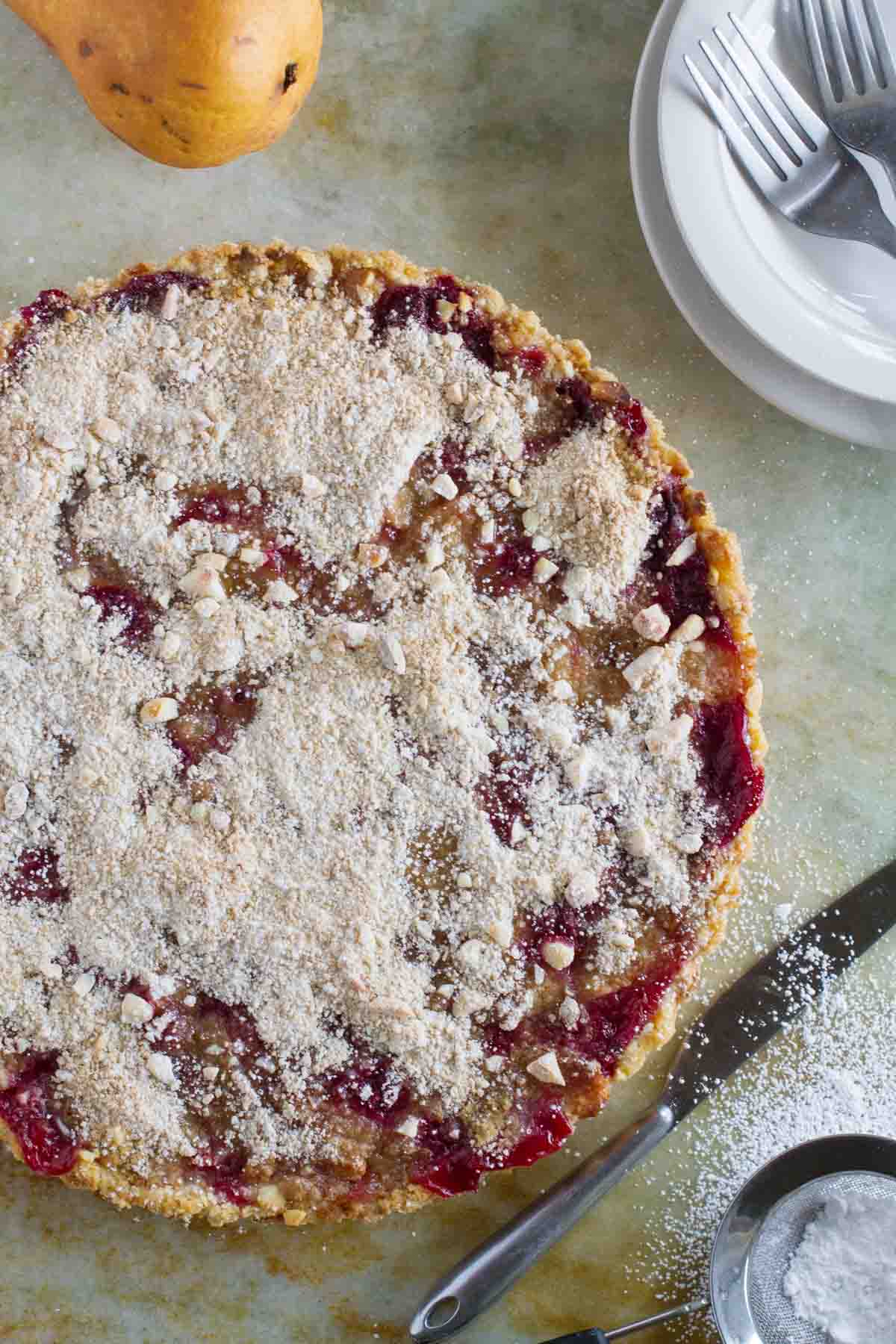 Full Pear and Raspberry Tart topped with macadamia nut streusel.