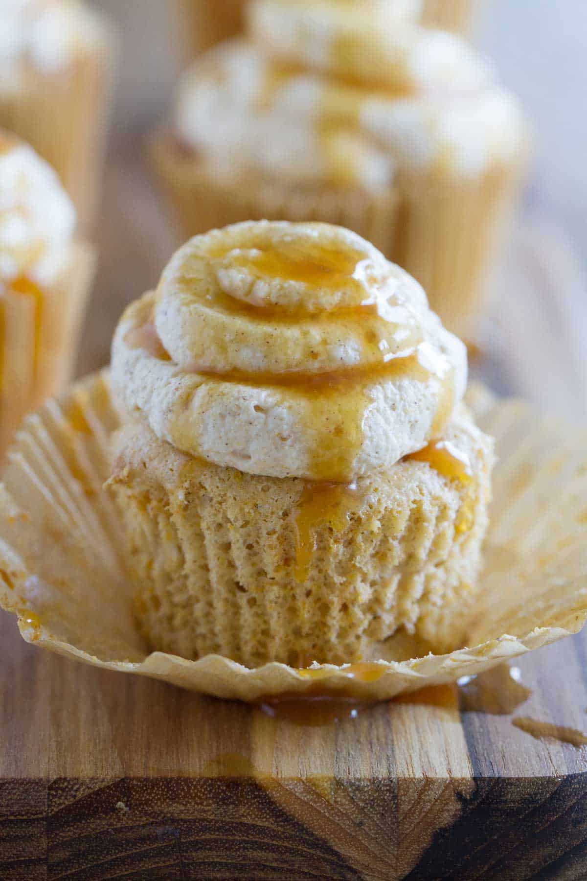 Pumpkin Angel Food Cupcake drizzled with caramel with the wrapper taken off.