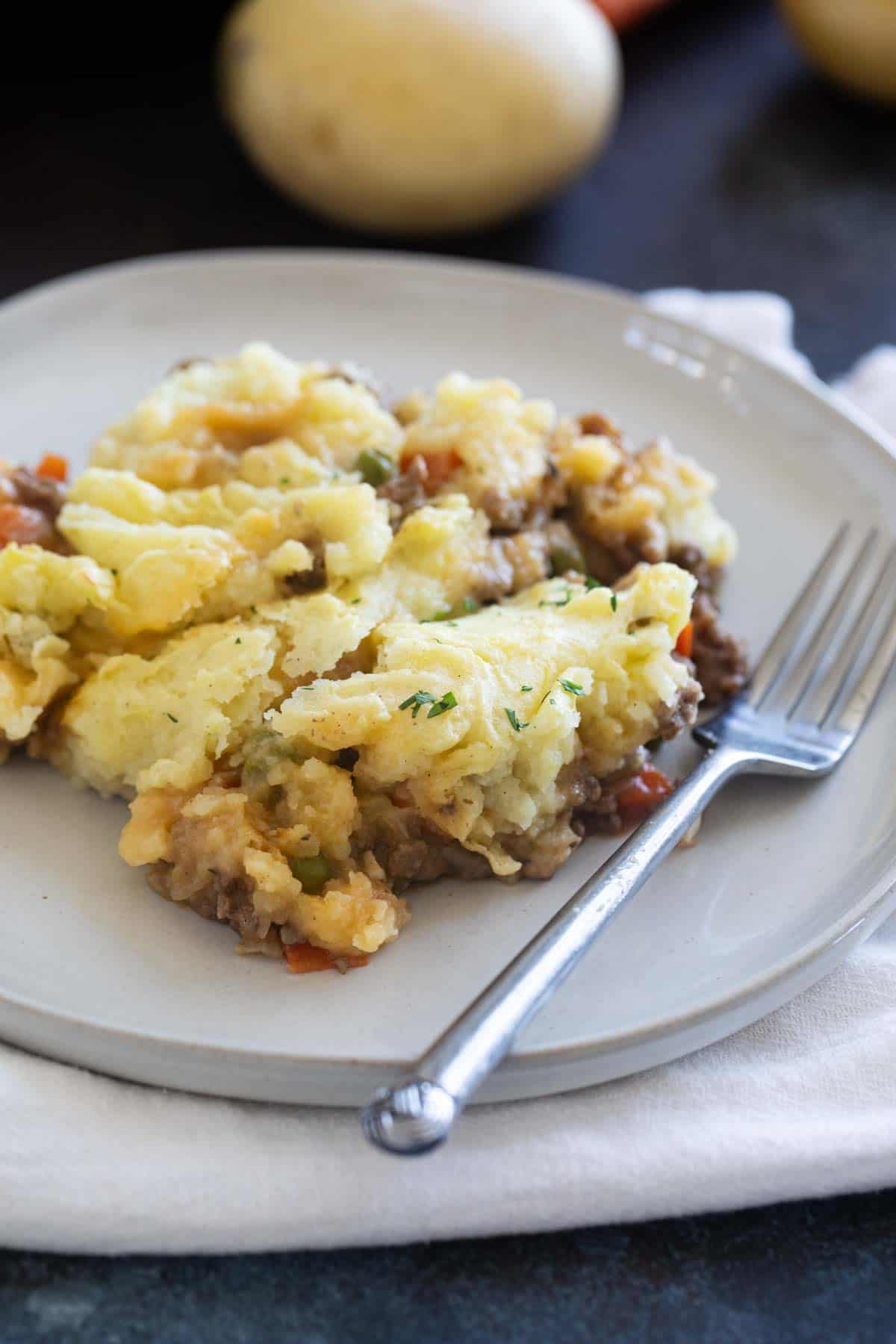 Plate with a serving of Shepherd's Pie with a fork.