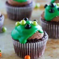 Ultimate Chocolate Cupcakes topped with green ganache and candy balls.