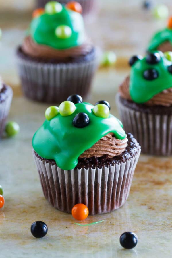 Ultimate Chocolate Cupcakes topped with green ganache and candy balls.