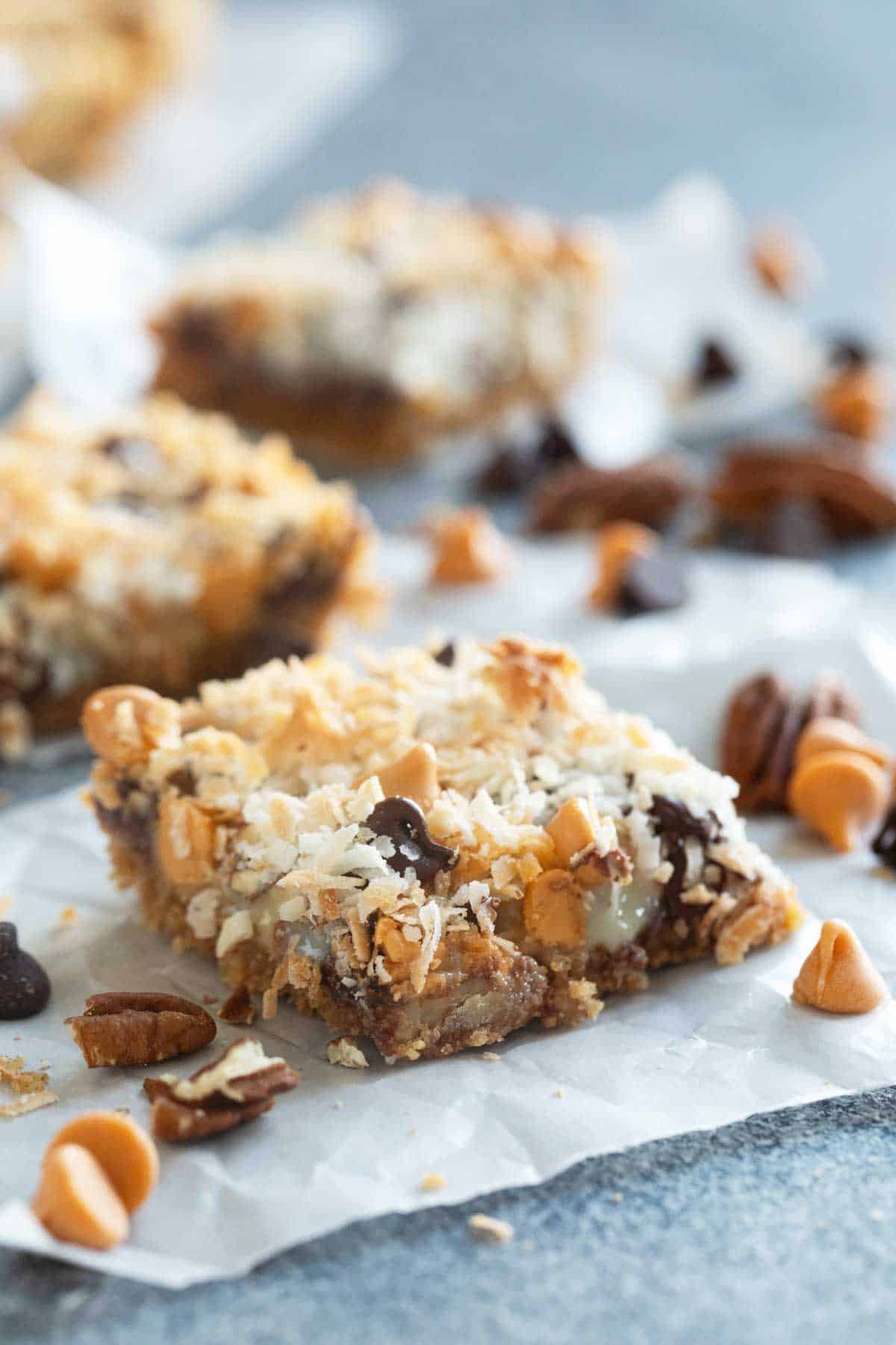 7 Layer Bars with a graham cracker crust, sweetened condensed milk, chocolate chips, butterscotch chips, pecans, and coconut.