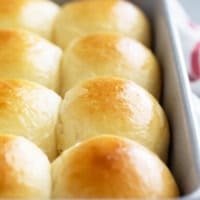 Baked Brioche Rolls in a baking dish.