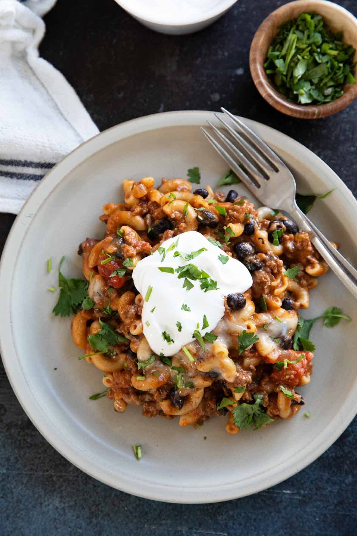 Chili Mac with black beans, topped with sour cream and chopped cilantro.