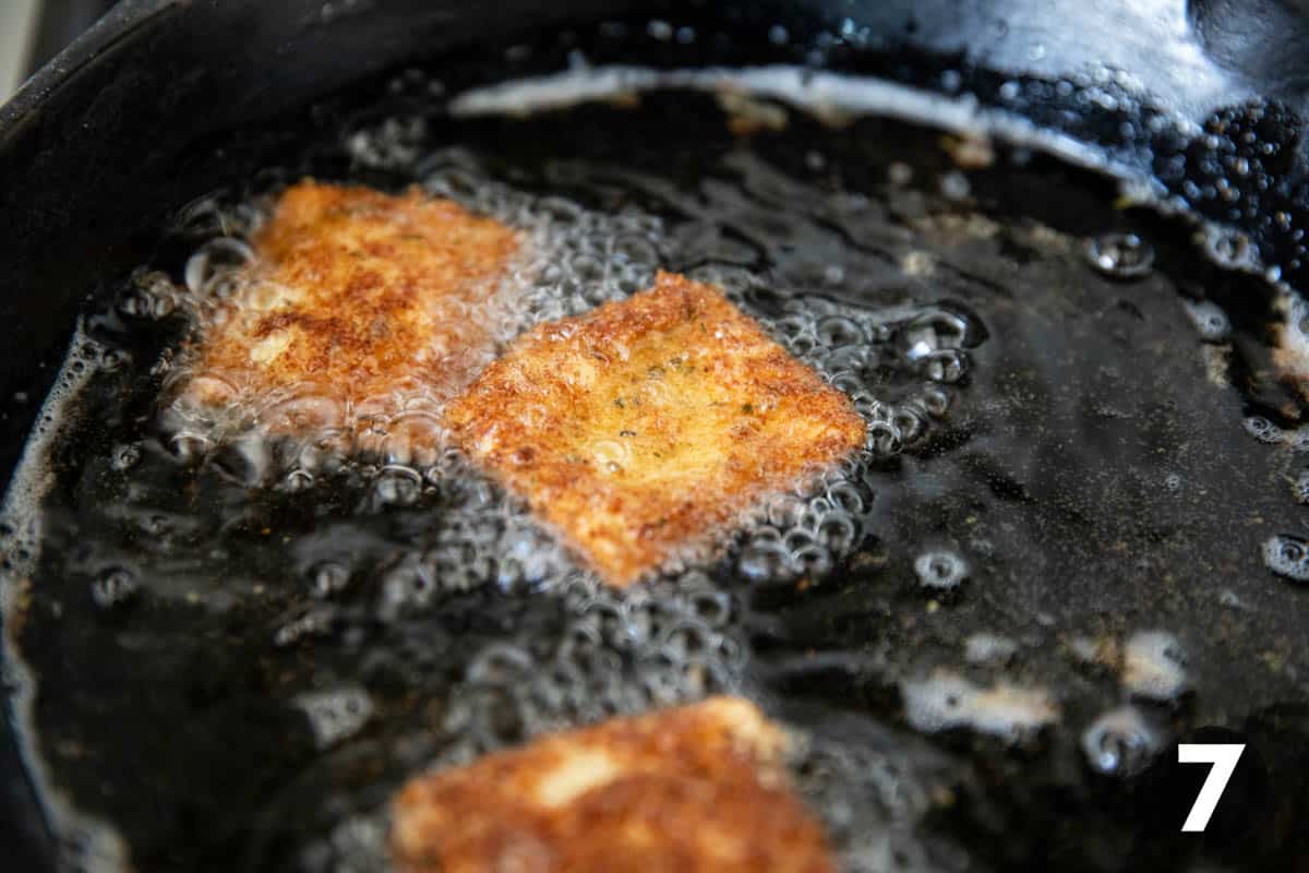 Frying ravioli in a cast iron skillet.