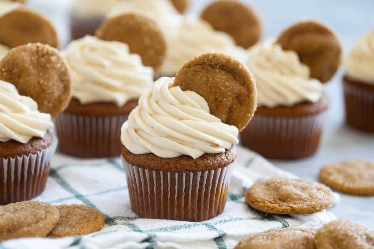 Gingerbread cupcakes topped with soft ginger cookies.