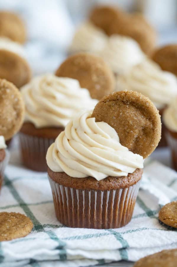 Gingerbread Cupcakes topped with brown sugar cream cheese icing and a ginger cookie.