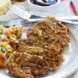 Piece of Potato Chip Chicken cut into slices on a plate.