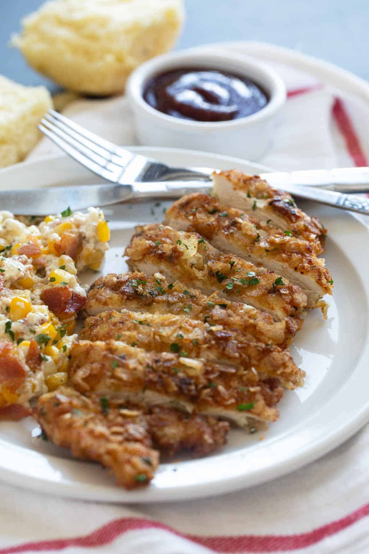 Piece of Potato Chip Chicken cut into slices on a plate.