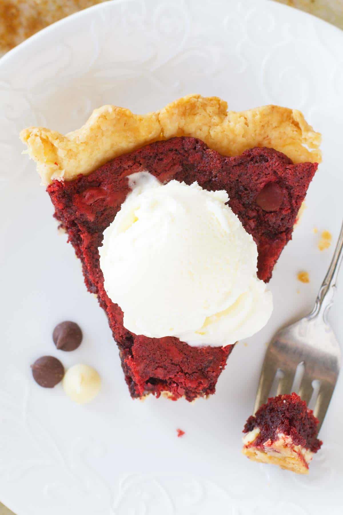 Slice of red velvet cookie pie with a bite taken from it.