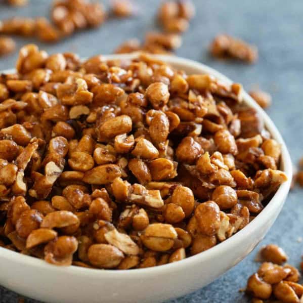 White bowl filled with toffee peanuts.