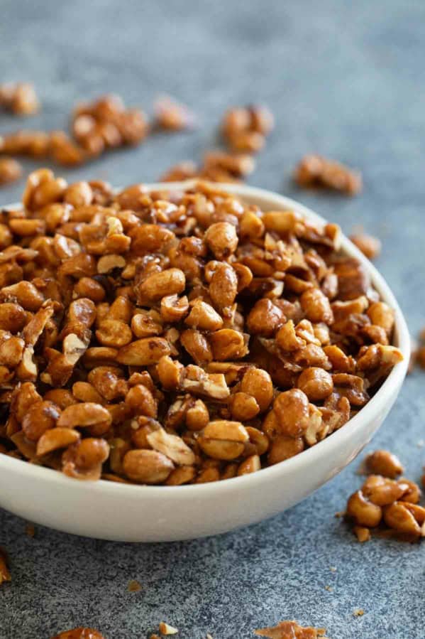 White bowl filled with toffee peanuts.