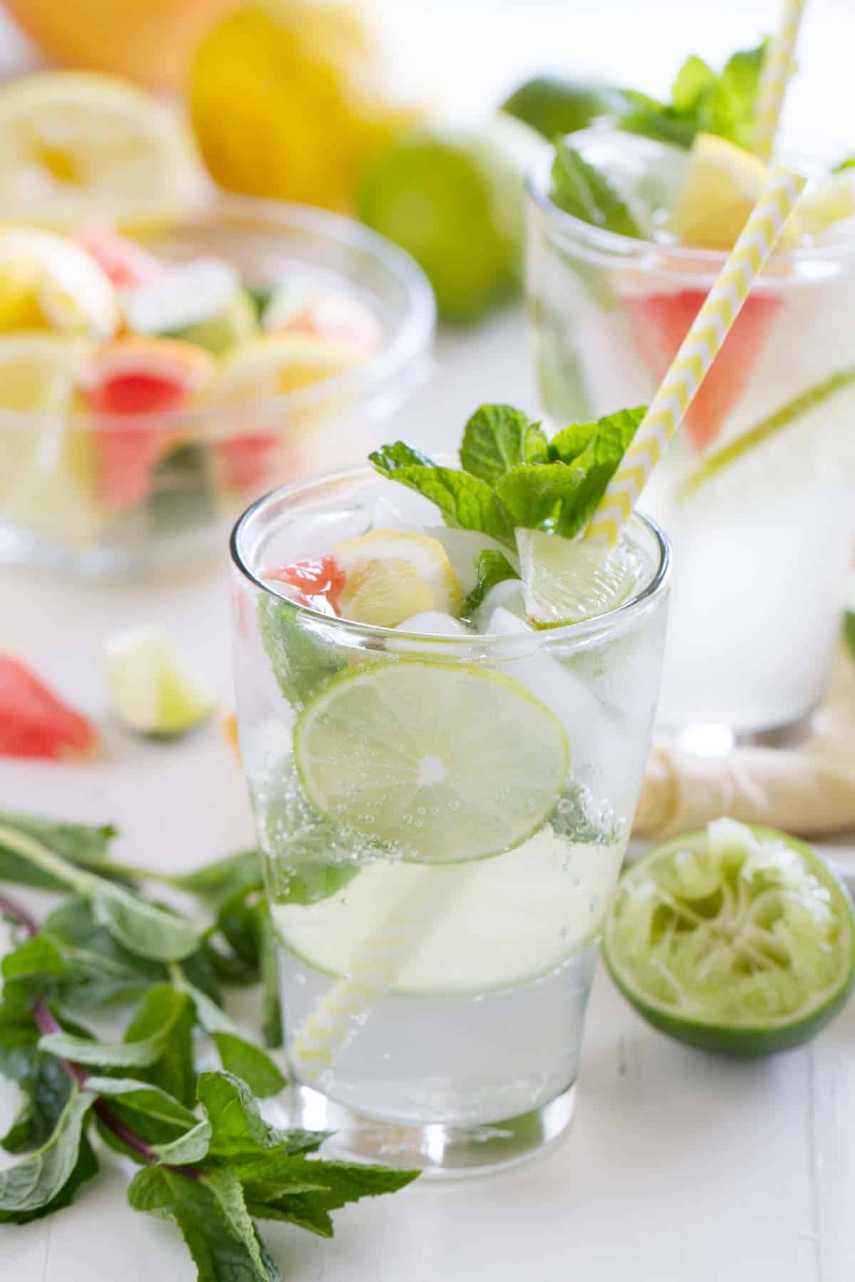 Virgin Mojito (Nojito) with a striped straw and fresh mint.