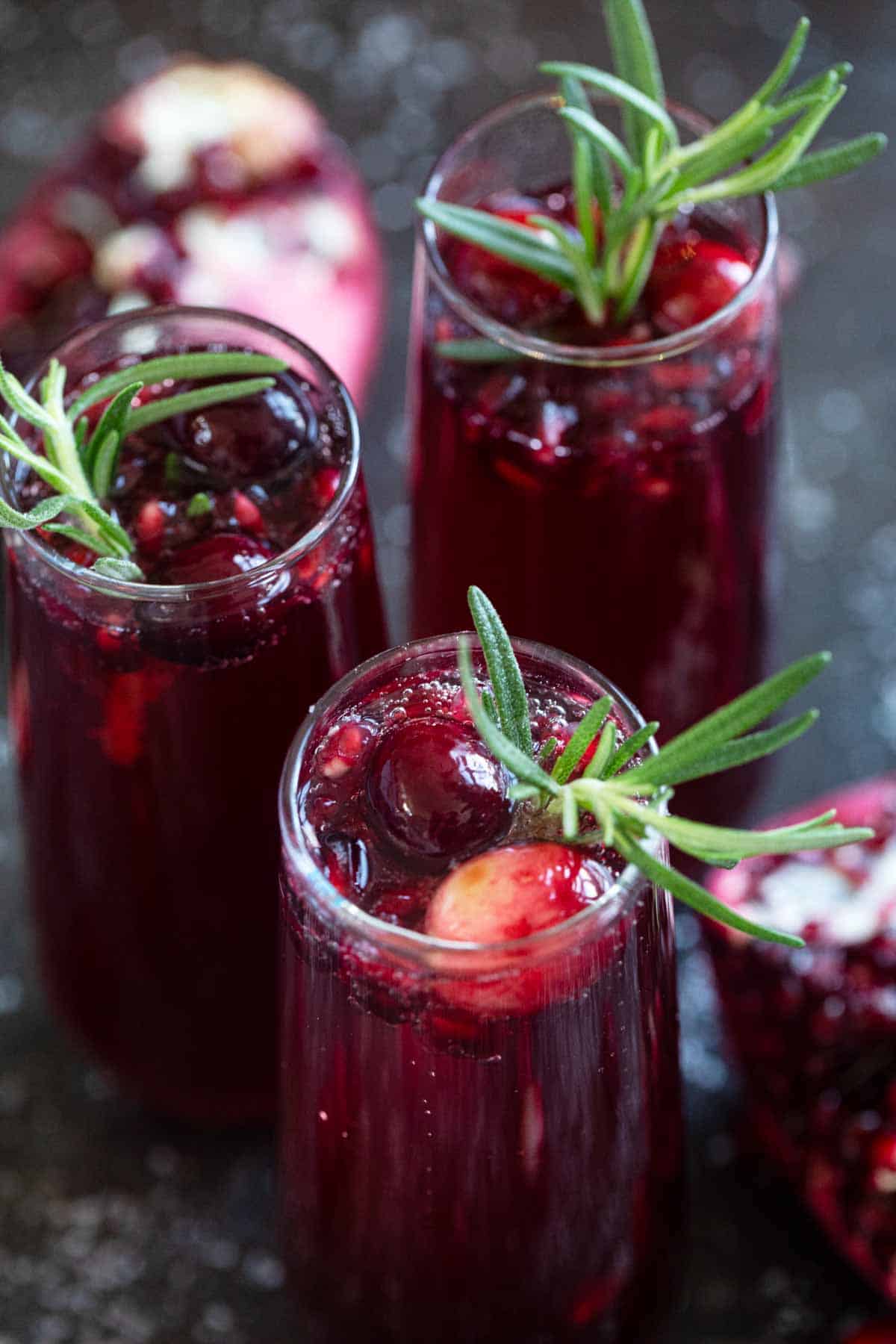 Virgin Pomegranate and Cranberry Bellini topped with rosemary and cranberries.