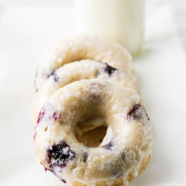 Three blueberry cherry baked donuts with glaze.