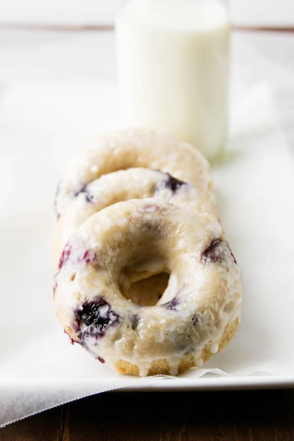 Three blueberry cherry baked donuts with glaze.