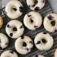 Blueberry Cherry Baked Donuts on a cooling rack.