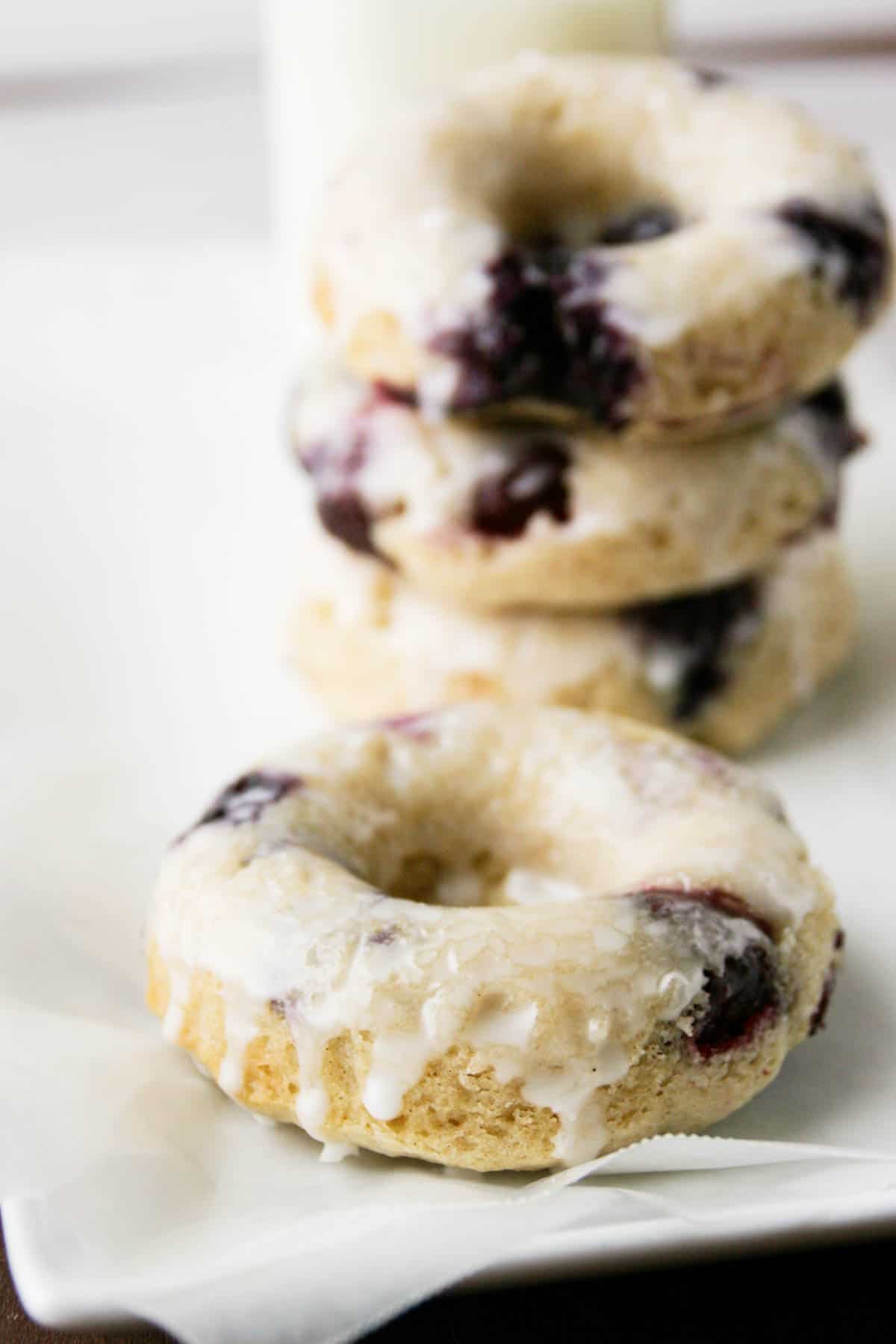 Blueberry Cherry Baked Donut with three donuts stacked in the background.