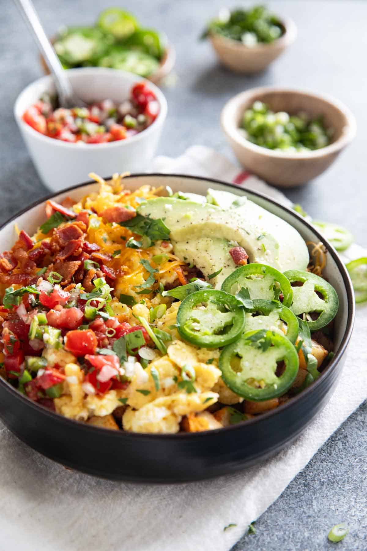 Breakfast Bowl with small bowls of toppings in the background.