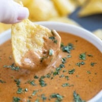 Dipping a chip into Chili's Queso Dip.