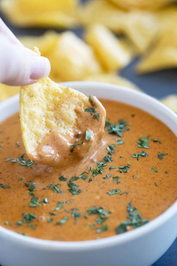 Dipping a chip into Chili's Queso Dip.