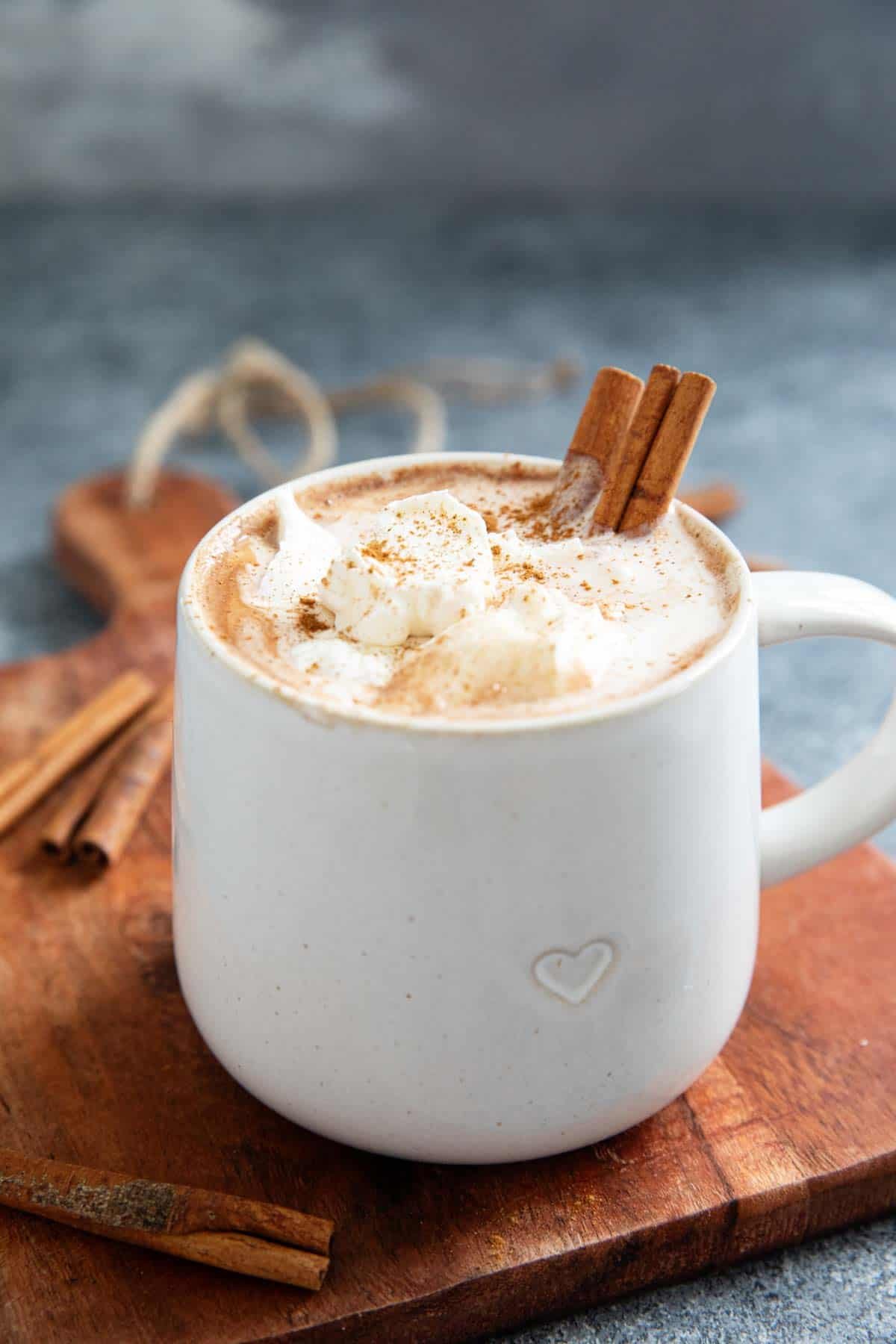 Mug of Mexican Hot Chocolate, topped with whipped cream and sprinkled with cinnamon.