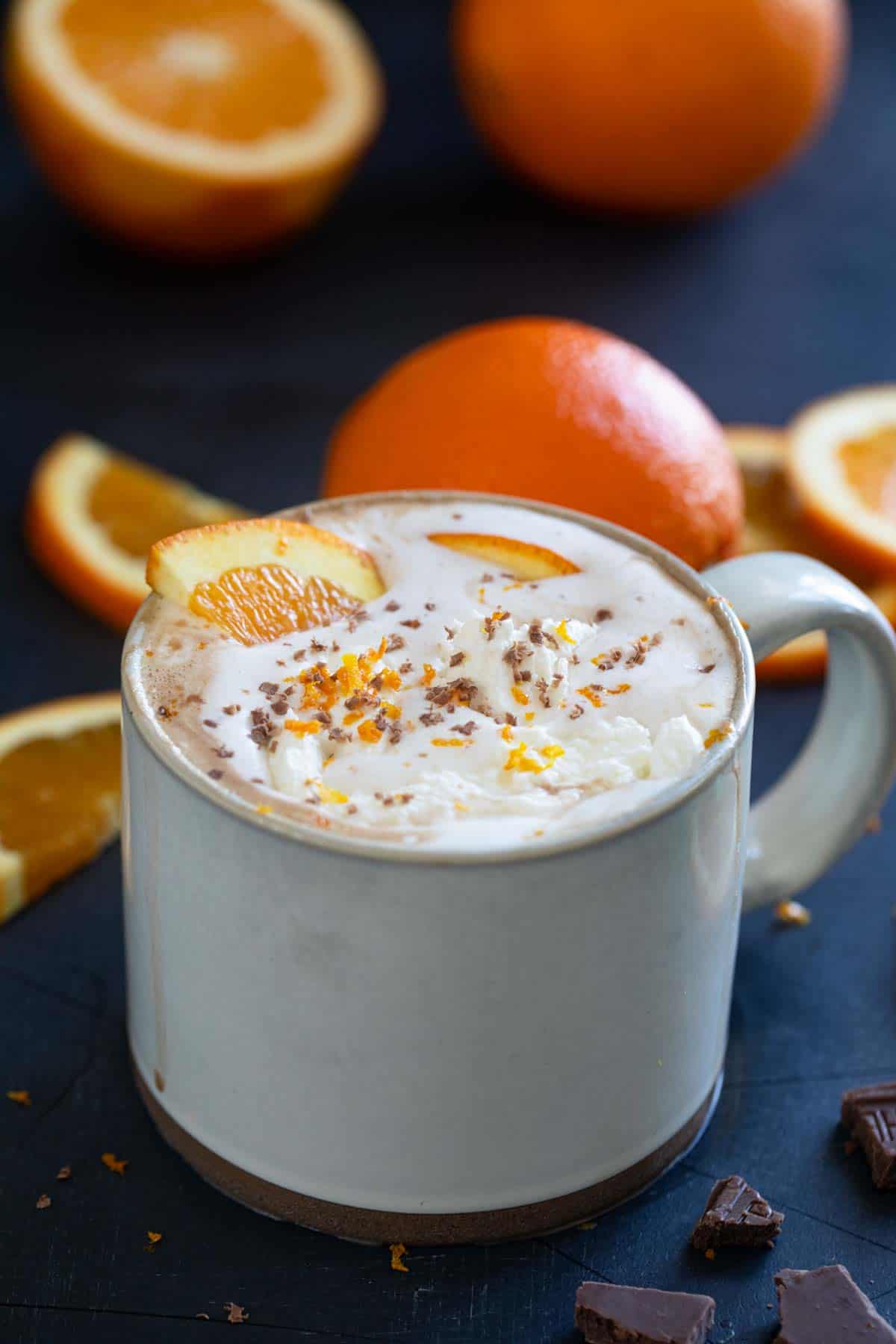 Orange Hot Chocolate topped with whipped cream, chocolate shavings, and orange zest.