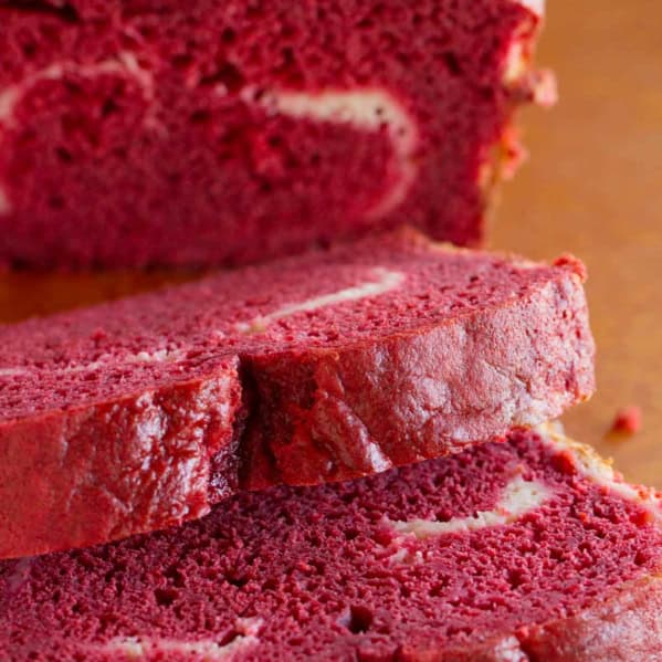 Slices of red velvet quick bread showing texture.