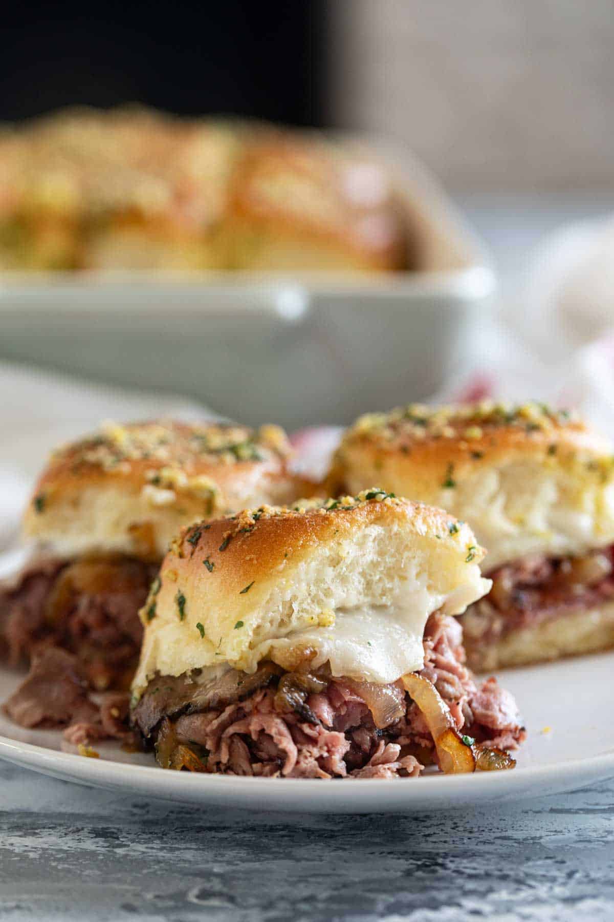 Roast Beef Sliders with caramelized onions on a plate.